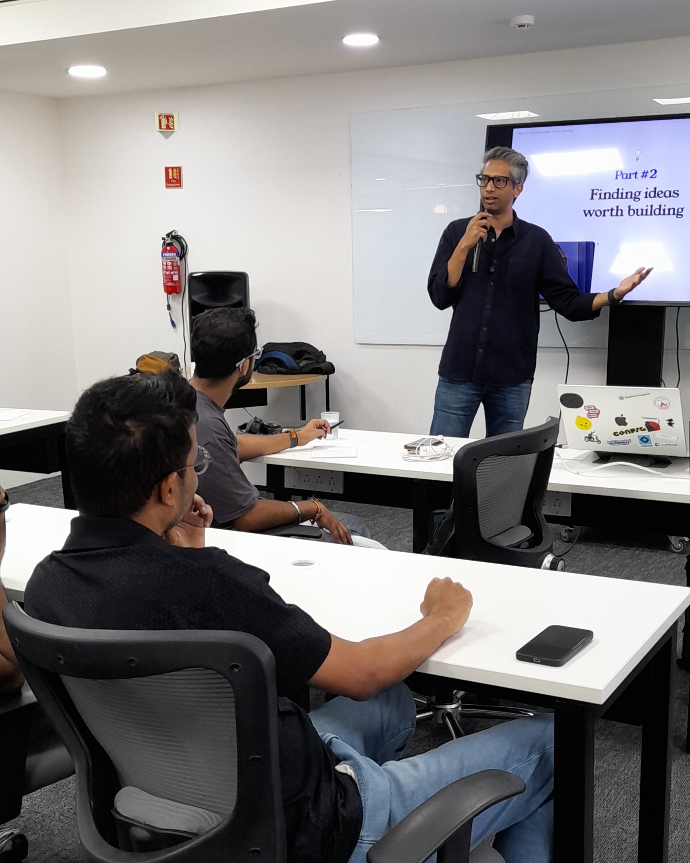 Sankalp Sinha speaking at The GTM School in Bengaluru, in front of his slide Part #2: Finding ideas worth building
